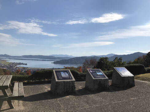 公園の入口付近にはデッキチェアや案内板が設置されています。遙かに三角形をした青葉山を遠望できます。